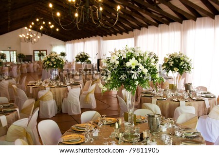 Indoors wedding reception venue with décor, selective focus on flowers Royalty-Free Stock Photo #79811905