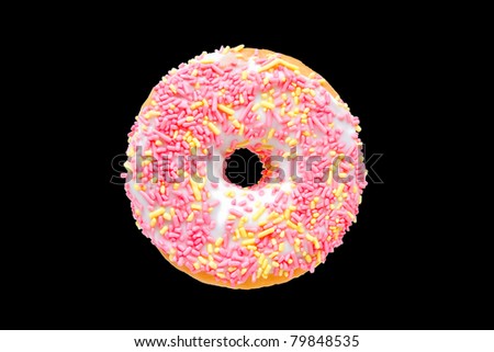 Donut with Pink and Yellow Sprinkles Isolated on a Black Background.  This file includes a clipping path.