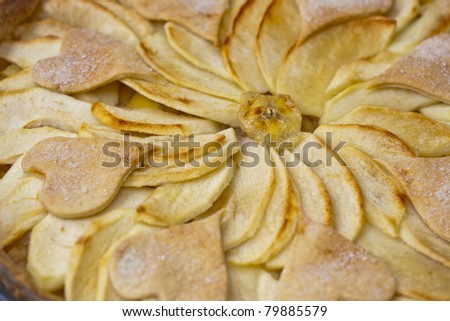 Homemade apple pie decorated with hearts.