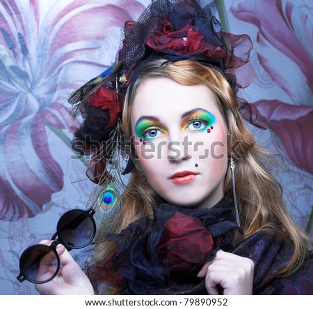 Young woman in creative image and with vintage sunglasses