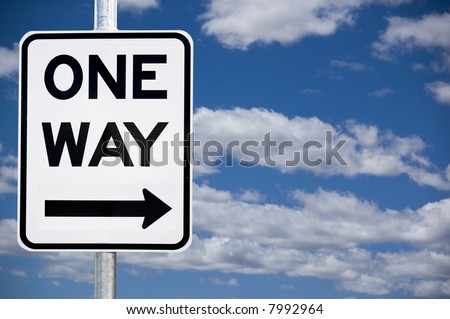 "One Way" street warning sign against a blue sky background