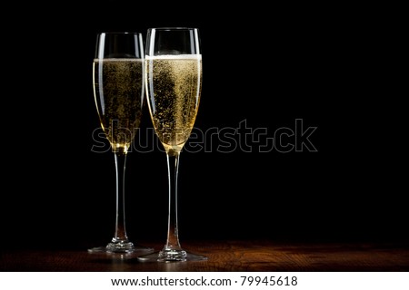 two glass with champagne on a wooden table Royalty-Free Stock Photo #79945618
