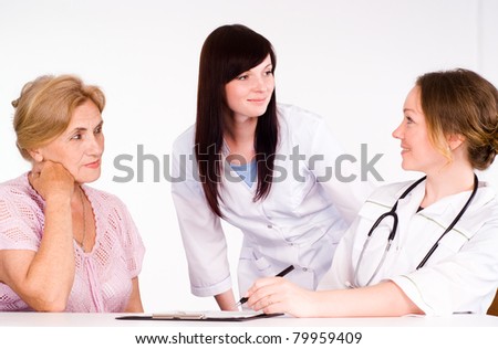 two doctors and a patient on a white