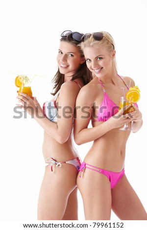 Two young attractive girl with a cocktail on a white background