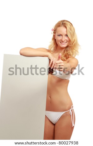 A young woman in a swimsuit with a blank, showing ok, isolated on white