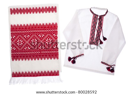 National Ukrainian traditional ornate handicraft symbol embroidery in red cross-stitch handmade white towel and cotton vyshyvanka menâ??s shirt with ornamental pattern isolated