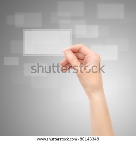 Female hand holding translucent electronic business card on a gray background.