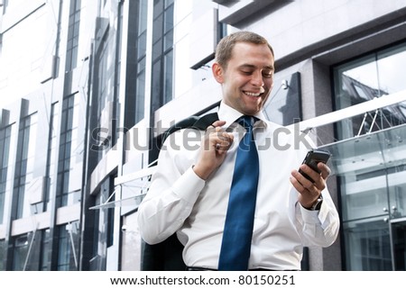 Young and successful businessman is reading a message on his smartphone Royalty-Free Stock Photo #80150251