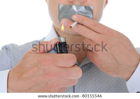 Businessman lights a cigarette. Isolated on white background