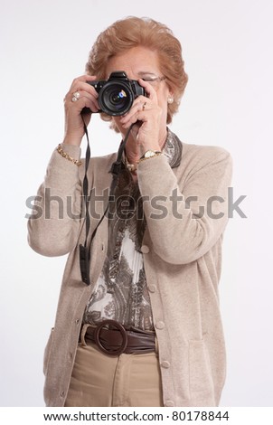 Senior lady shooting with a camera