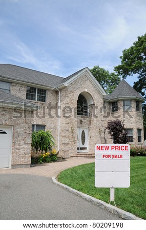 For Sale Sign post on Lawn of Luxury Residential Suburban Home
