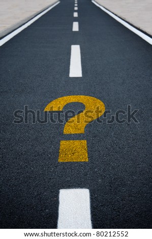 Question mark on asphalt road. Travel to unknown destination concept.