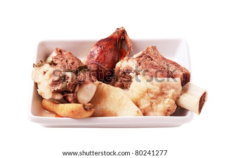 Boiled beef and root vegetables in a porcelain dish