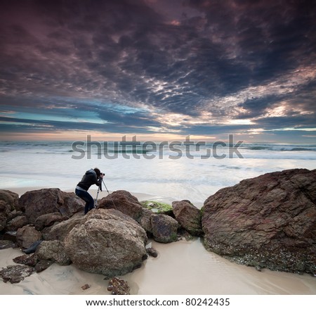 woman photographer takes photo of the beautiful seascape (miami beach, queensland, australia)