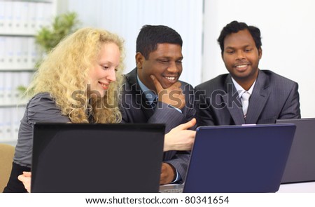 Interracial business team working at laptop in a modern office