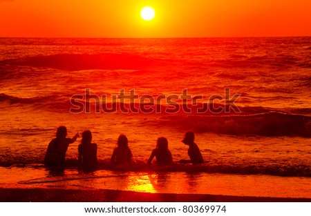 children on the beach at at sunset