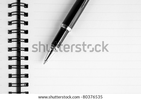 Notebook and pen in composition in black and white