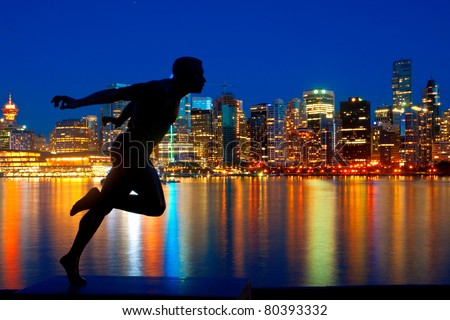 Statue in Stanley Park, Vancouver, British Columbia with a beautiful view of the city skyline behind.