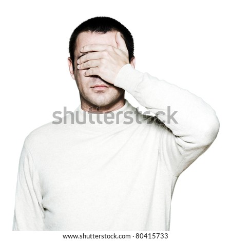 Portrait of a handsome man covering his eyes with hand in studio on white isolated background