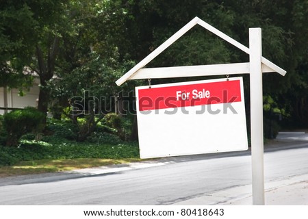 Sign for sale in a residential area.
