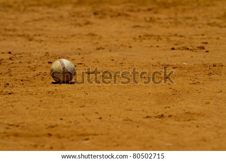 Baseball lies on a playing field