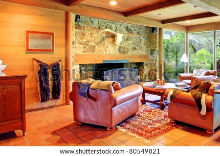 Cowboy ranch in Washington State with leather sofas and stone fireplace.