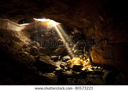 Single beam from the sun that shines into the mouth of a cave in the provinces of Thailand