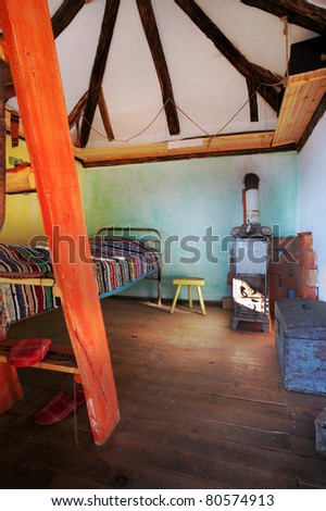 Interior of an old village wooden house, room with old-fashioned furniture.