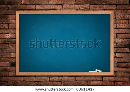 Blue blackboard on old wall background