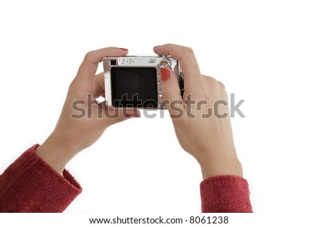Caucasian female holding up a Point and Shoot digital camera to take a photograph