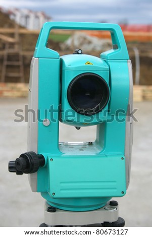Theodolite equipment on construction site on cloudy day