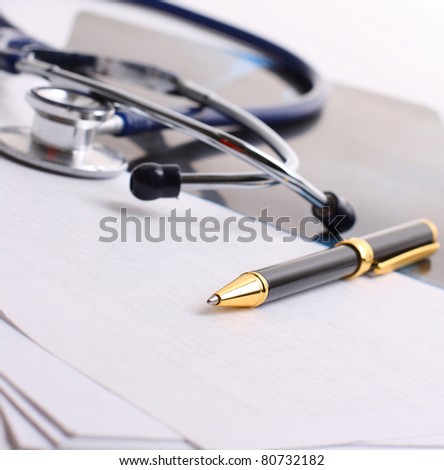 stethoscope with the handle and papers