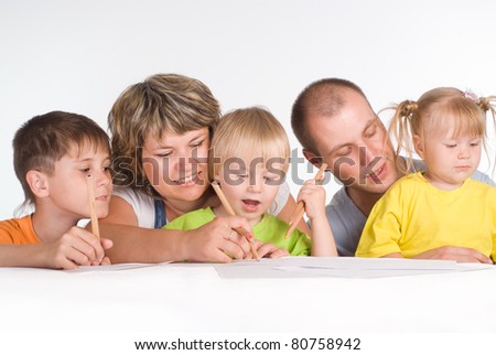 happy family drawing at the table on a white