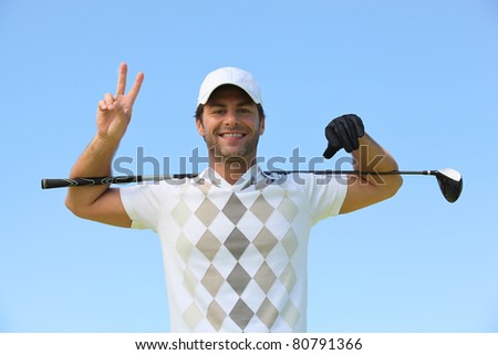 Happy golfer giving peace sign