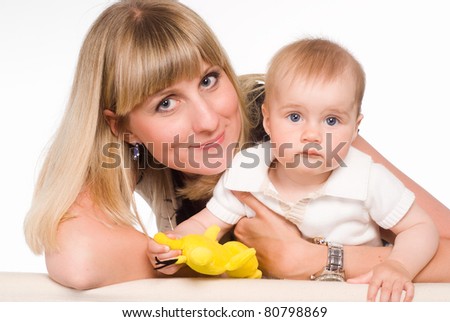 mom playing with her son on a white