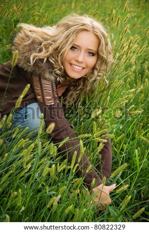 Portrait of beautiful happy girl on green background.