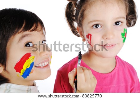 Two children painting on faces of each other