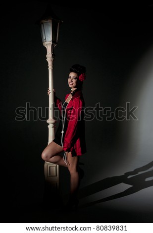 beautiful young glamorous woman  with light pole