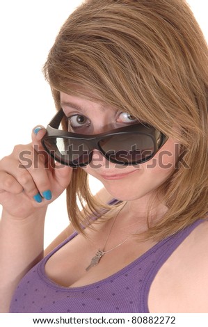 A teenager, brunette, looking over her sunglasses into the camera in closeup for white background.