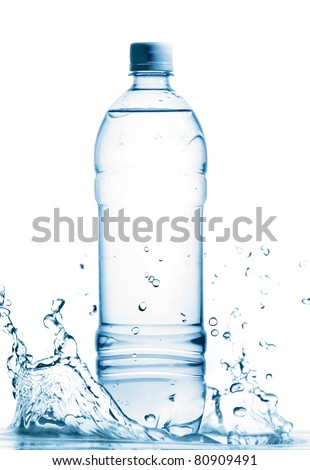 bottle of mineral water is standing in splashing water, cut out from white Royalty-Free Stock Photo #80909491