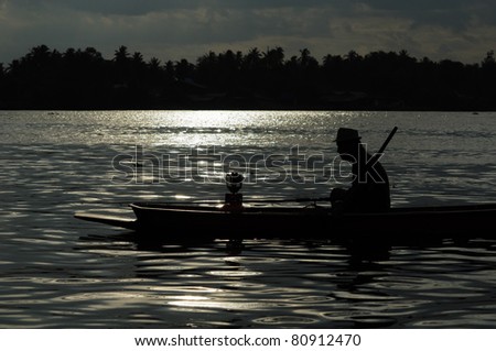Silhouette of the fisherman on the boat