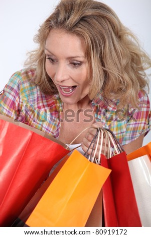 Woman looking surprised with shopping bags