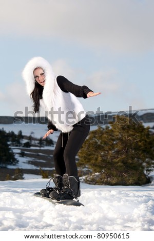 girl with a snowboard on the mountain is