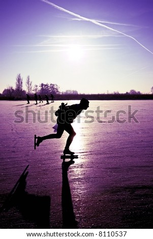 Ice skating with a beautiful purple sunset in the countryside of the Netherlands