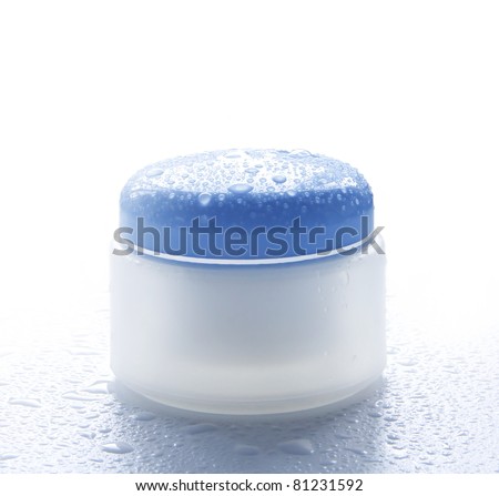 Cosmetic cream for skin care in the water droplets Royalty-Free Stock Photo #81231592