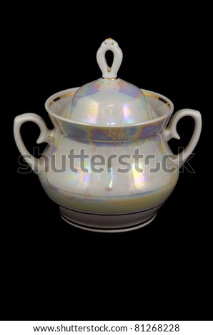 porcelain jug of sugar on a black background