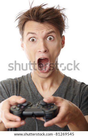 Young crazy man plays computer game with joystick