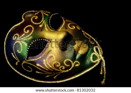 Golden Venetian mask, isolated on black background.