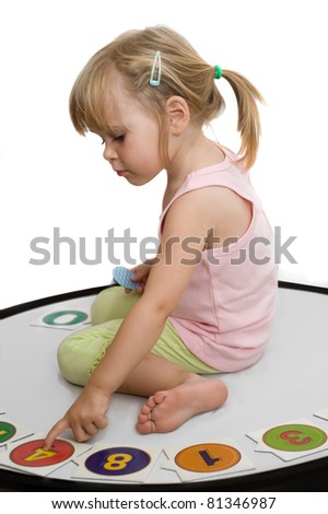 little girl plays pictures with numbers