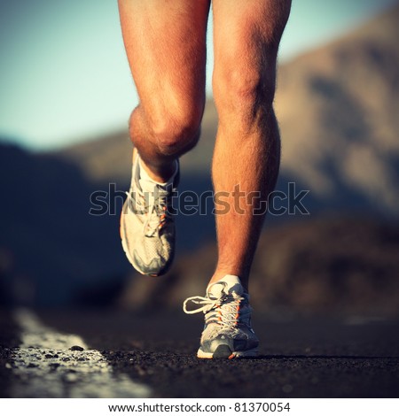 Running sport. Man runner legs and shoes in action on road outdoors at sunset. Male athlete model. Royalty-Free Stock Photo #81370054
